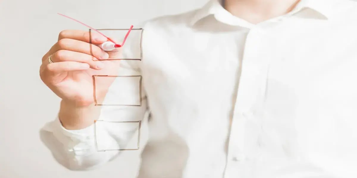 businessperson-s-hand-marking-check-box-with-red-marker-screen